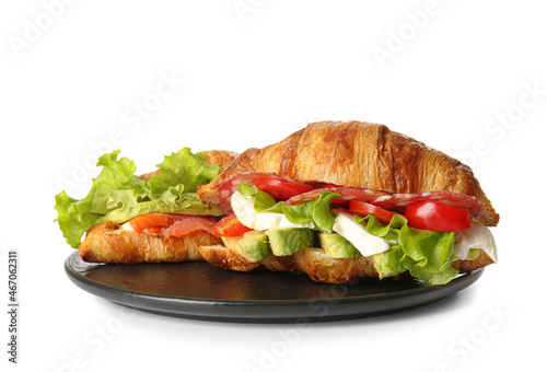 Plate with delicious croissant sandwiches on white background
