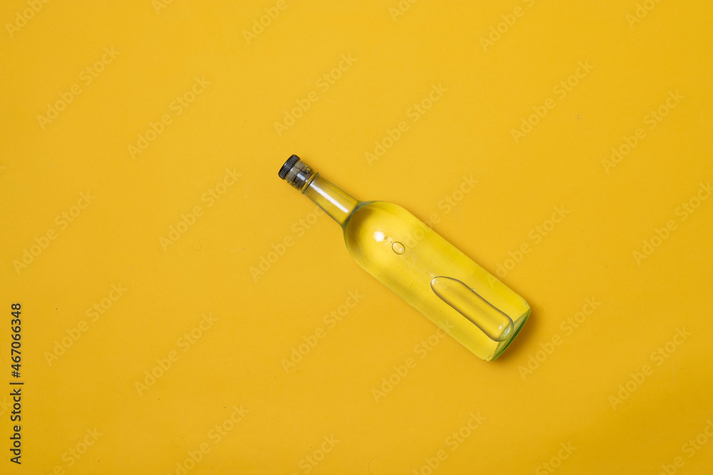 top view of bottle of tequila, mezcal or vodka on yellow background top view of bottle of tequila, mezcal or vodka on yellow background