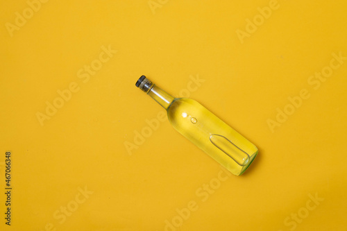 top view of bottle of tequila, mezcal or vodka on yellow background