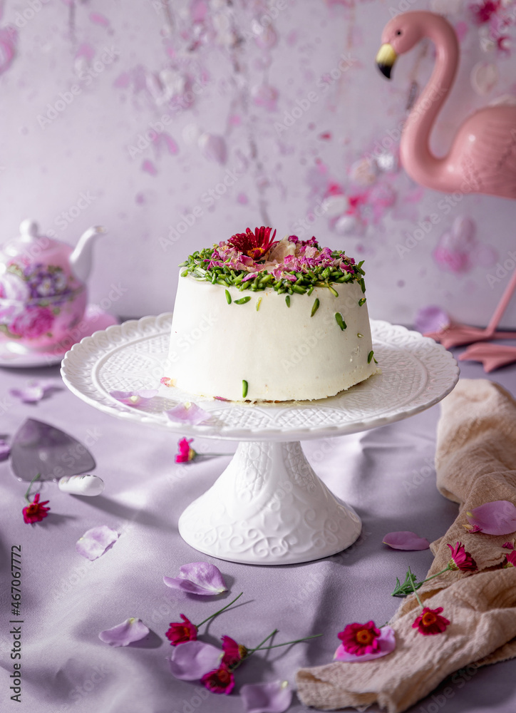 Close up shot of black tea rose & Pistachio cake against violet color background.