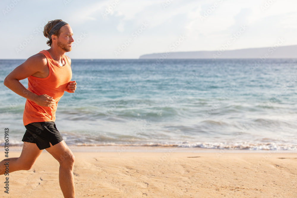 Running sport man profile of athlete training on beach with landscape copy space. View of sunset summer ocean. Exercise active lifestyle. Running sport man profile of athlete training on beach with landscape copy space. View of sunset summer ocean. Exercise active lifestyle.