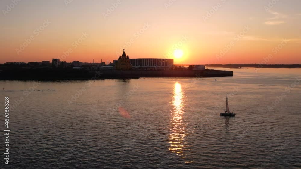 A large ship at sunset is moving at the confluence of two rivers.The sun is at sunset.Golden sunset.A cruise ship is sailing on the river. A large ship at sunset is moving at the confluence of two rivers.The sun is at sunset.Golden sunset.A cruise ship is sailing on the river.