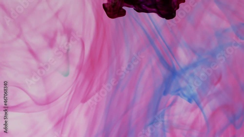 Multicolor pigment ink water explosion from above white background.