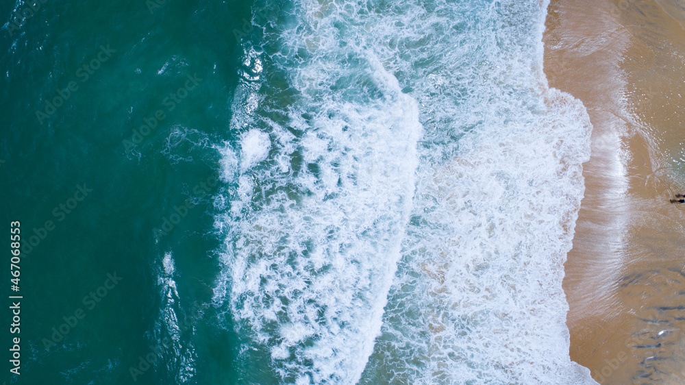 Aerial view sandy beach and waves Beautiful tropical sea in the morning summer season image by Aerial view drone shot, high angle view Top down