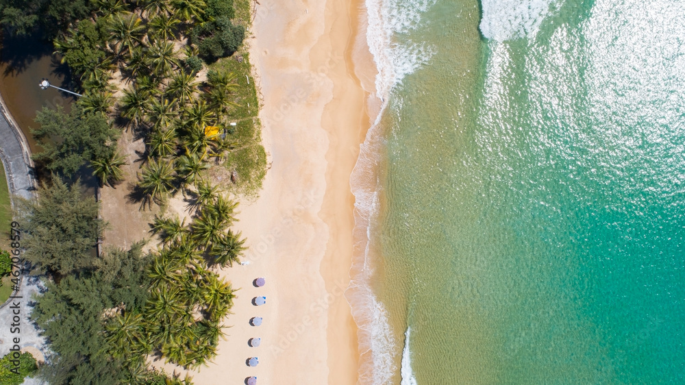 Aerial view top view of Coconut palm trees on the beautiful Karon beach Phuket Thailand Amazing sea beach sand tourist travel destination in andaman sea Beautiful phuket island Travel and tour concept