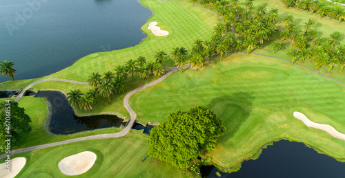 Aerial view drone shot of beautiful green golf field fairway and putting green Top down image for sport background and travel nature background Amazing view
