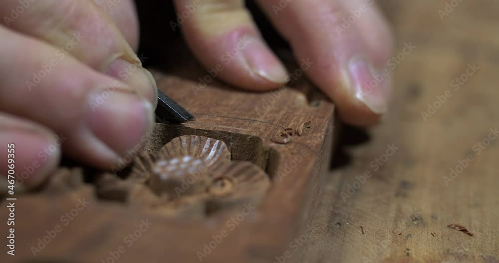 Close up of Chinese style carpenter carving on wood making traditional asian style furniture Close up of Chinese style carpenter carving on wood making traditional asian style furniture