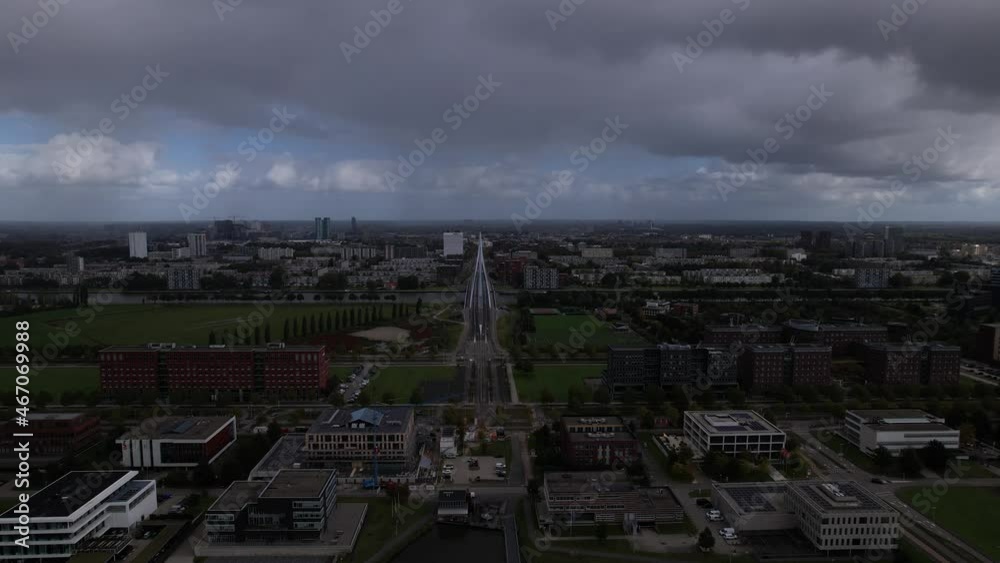 Aerial forward movement with Prins Clausbrug cable bridge city access to Utrecht in the distance with residential neighbourhood. Infrastructure and Dutch urban planning, engineering and transportation Aerial forward movement with Prins Clausbrug cable bridge city access to Utrecht in the distance with residential neighbourhood. Infrastructure and Dutch urban planning, engineering and transportation