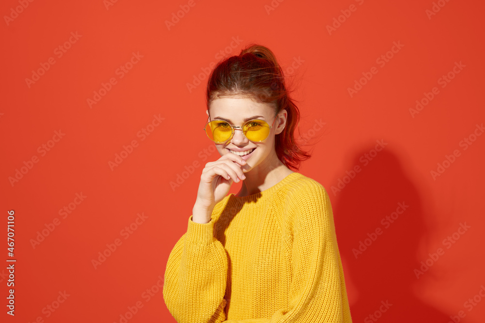 cheerful woman in yellow glasses holding her head fashion red background cheerful woman in yellow glasses holding her head fashion red background