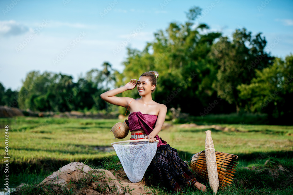 Young woman in beautiful Thai traditional clothes at rice field Young woman in beautiful Thai traditional clothes at rice field
