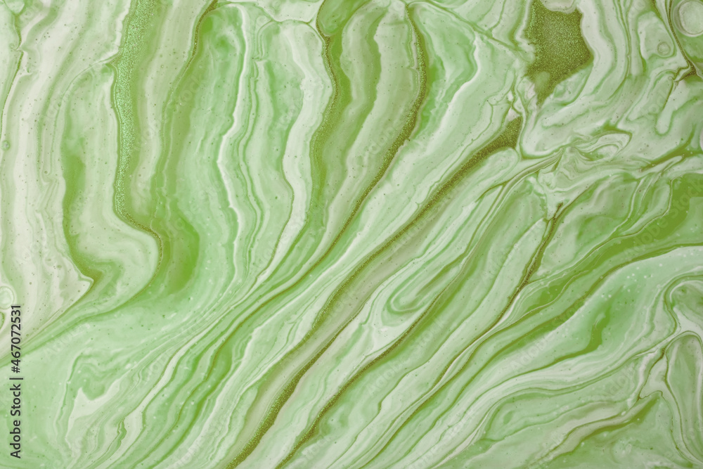 Abstract fluid art background green colors. Liquid marble. Acrylic painting on canvas with olive gradient and splash. Abstract fluid art background green colors. Liquid marble. Acrylic painting on canvas with olive gradient and splash.