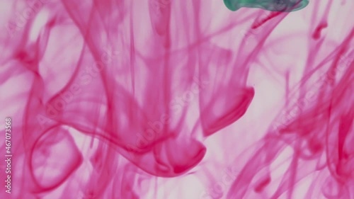 Multicolor pigment ink water explosion from above white background.