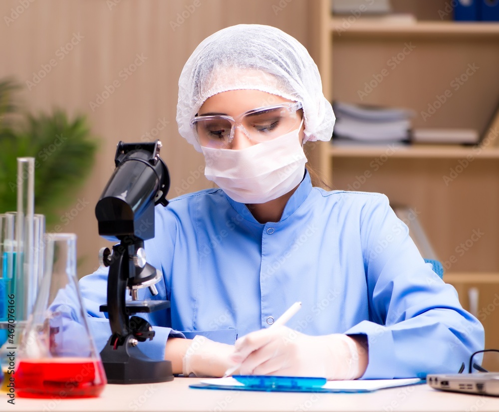 Lab chemist working with microscope and tubes Lab chemist working with microscope and tubes