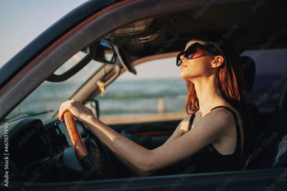 pretty woman in sunglasses driving a car trip