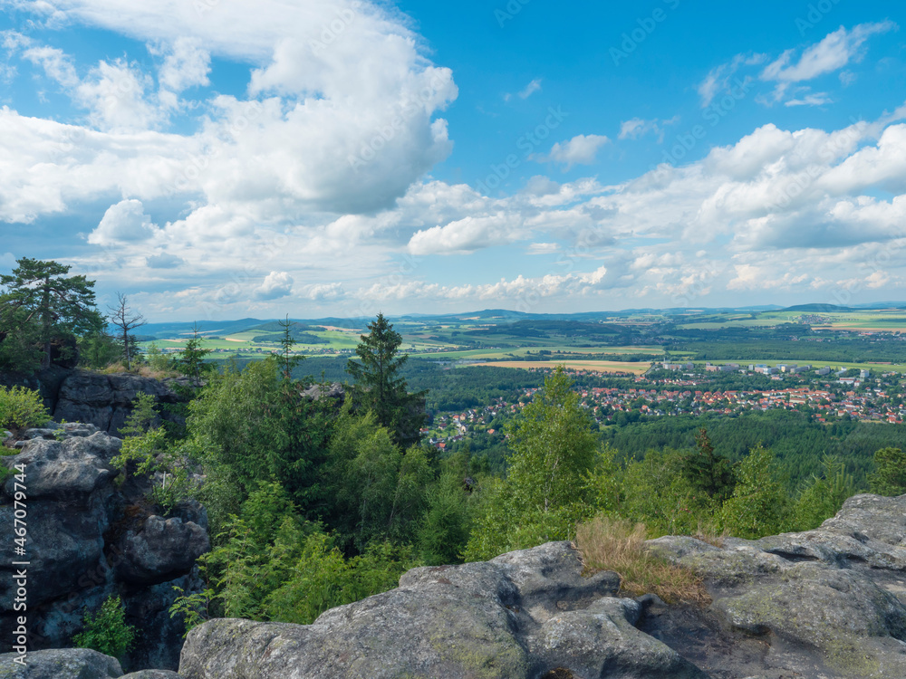 Tempelwand sandstone viewpoint next to hill Topfer near Oybin with view of Zittau town at Poland German borders in Zittauer Gebirge mountains, Saxony, germany. Summer sunny day, blue sky, white clouds