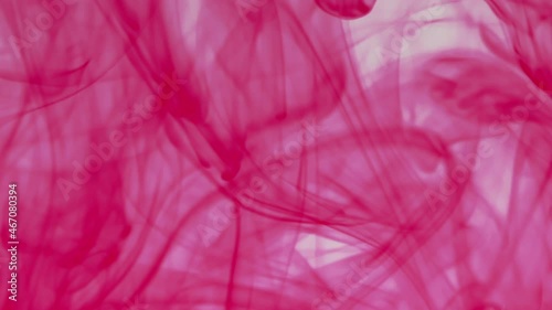 Red pigment ink water explosion from above white background.