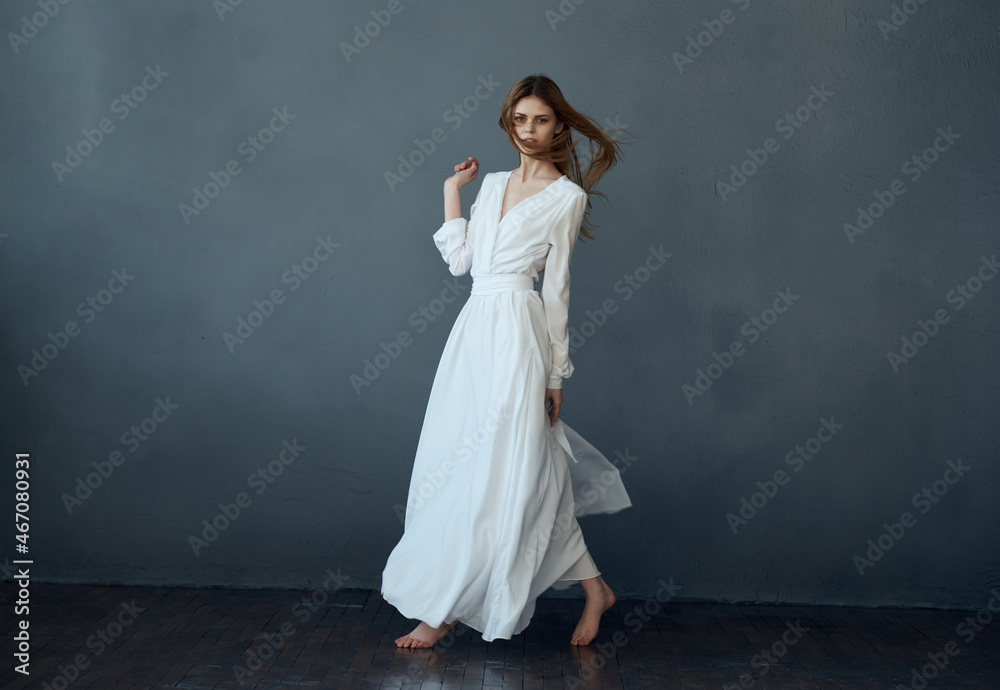 Woman in white dress dance posing isolated background Woman in white dress dance posing isolated background