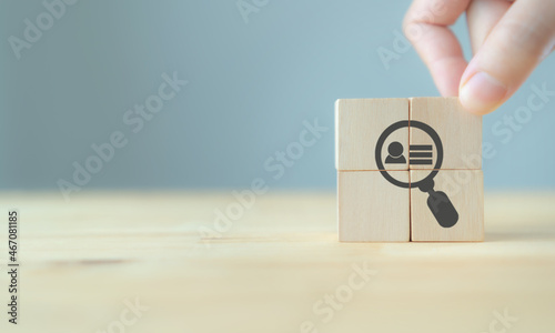 Buyer persona and target customer concept. Buyer or customer psychology profile or characteristics. Marketing analysis for business plan. Hand holds wood cubes with person data, magnifying glass.