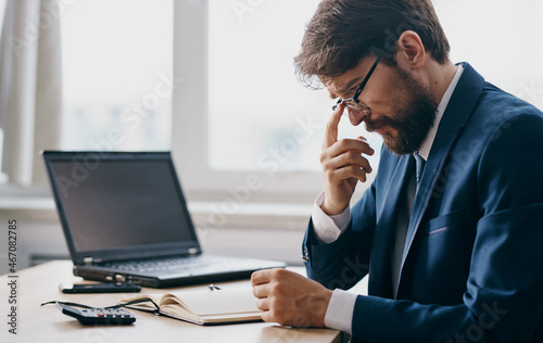 businessmen working for a laptop in the office emotions discontent professional