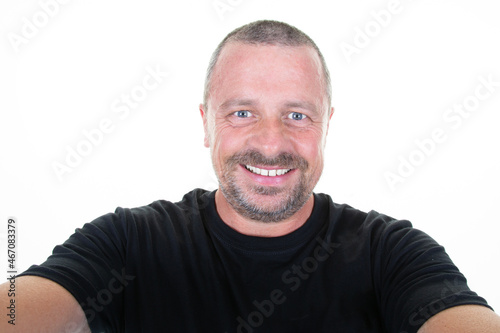 man making smartphone selfie with cellphone over isolated white background middle aged handsome guy portrait
