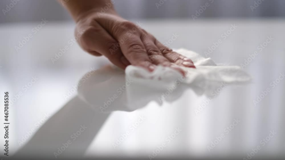 Woman cleaning and polishing the kitchen worktop with a spray detergent, housekeeping and hygiene concept Woman cleaning and polishing the kitchen worktop with a spray detergent, housekeeping and hygiene concept
