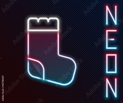 Glowing neon line Baby socks clothes icon isolated on black background. Colorful outline concept. Vector