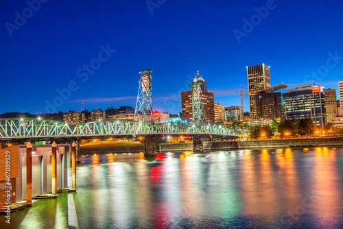 PORTLAND, OR - AUGUST 18, 2017: City buildlngs at night with river reflections of lights. © jovannig