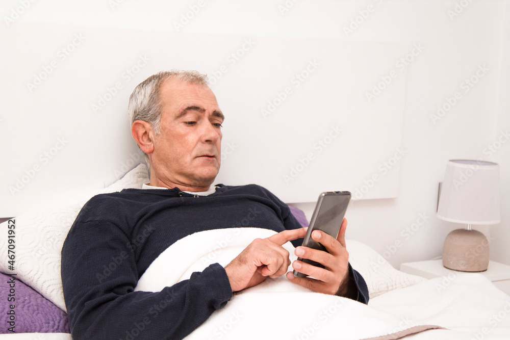 man in bed using mobile phone man in bed using mobile phone