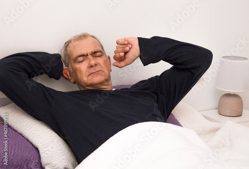 relaxed man lying in bed © tetxu