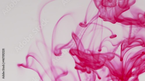 Red pigment ink water explosion from above white background.