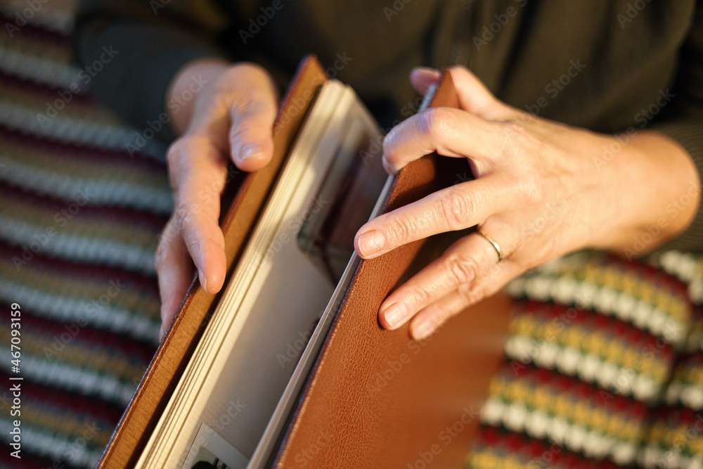 Old woman looking at family photo album