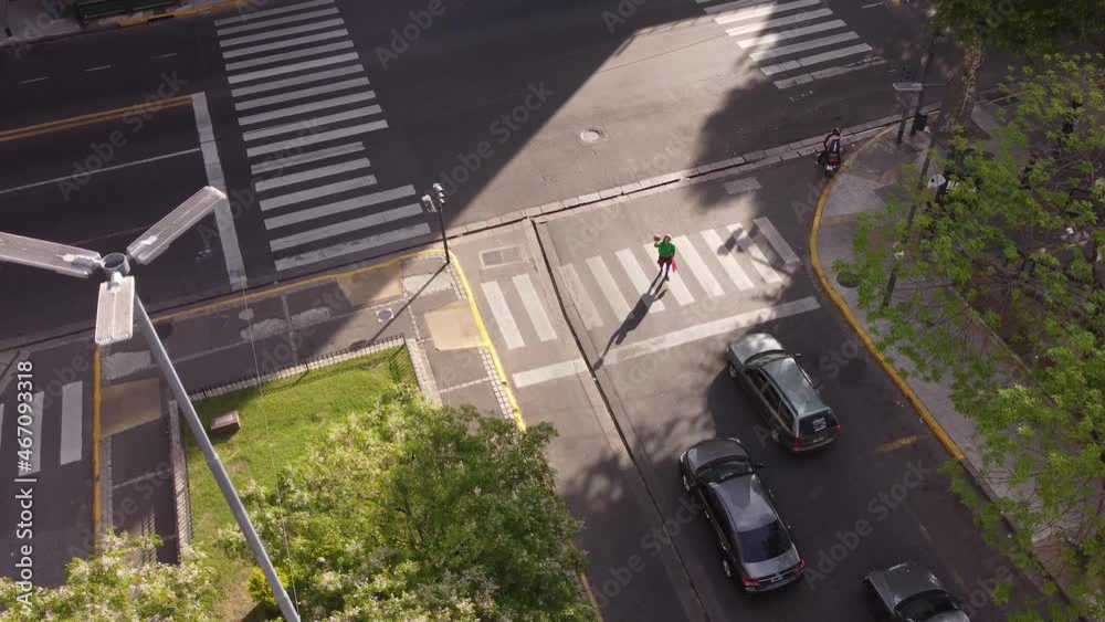 Aerial view of juggler performing at zebra crossing during red traffic light. Aerial view of juggler performing at zebra crossing during red traffic light.