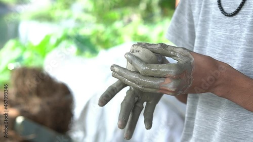 Hands of a poor Indian villager making simple handcrafted Kulhar (bhand) in a forest background.. photo