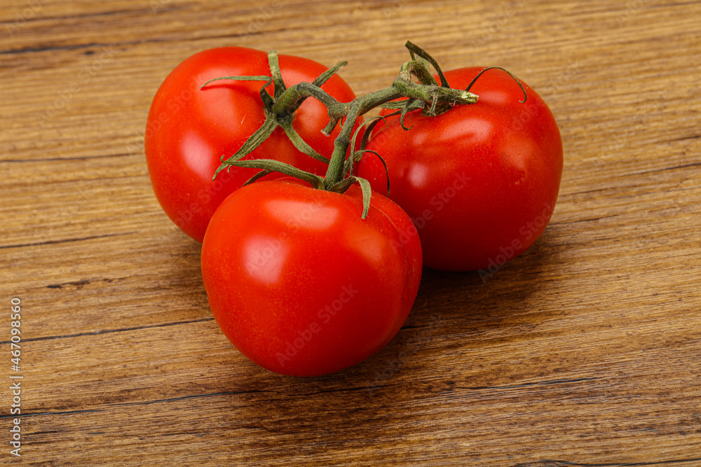 Red bright ripe tomato branch