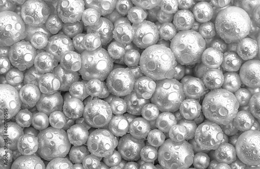 Beautiful background with mother-of-pearl white pearls, top view. Abstract texture for festive backgrounds. Shiny surface of Christmas decorations. Gems close-up. Silver bright background. Beautiful background with mother-of-pearl white pearls, top view. Abstract texture for festive backgrounds. Shiny surface of Christmas decorations. Gems close-up. Silver bright background.