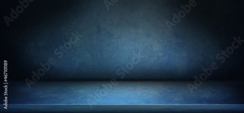 blue gradient abstract background of empty blue room in with spotlight on stage.