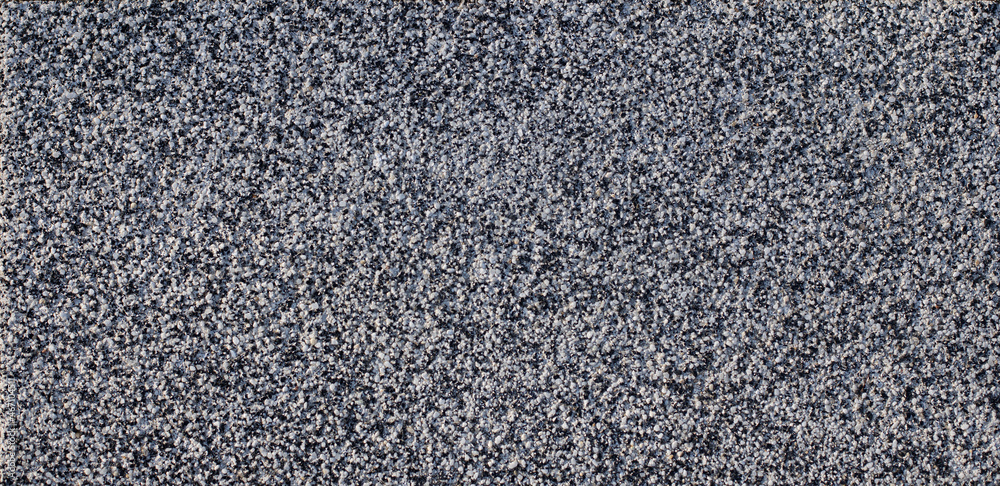 slab covered with small stones of quartz, white and black. background texture. slab covered with small stones of quartz, white and black. background texture.