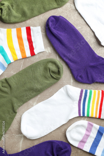 Different color socks on gray textured background