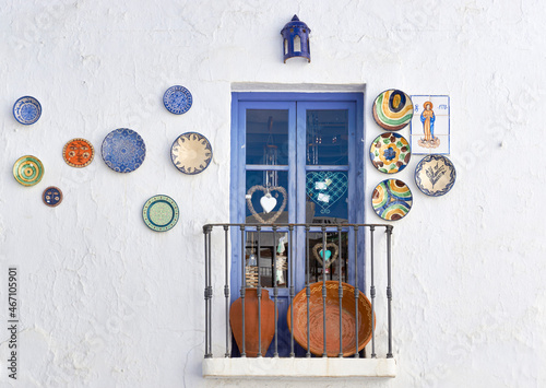 ornaments hanging on a wall in the village of Frigiliana, typical streets of the Axarquia in Malaga. Spain