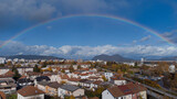 Panorama of siska district in Ljubljana, Slovenia accompanied by beautiful rainbow spanning over the horison over the Smarna Gora mouintain. Dreamy photo of a suburb.