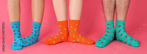 Legs in different socks on pink background photo