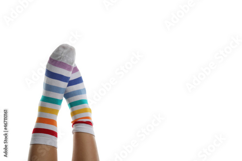 Female legs in rainbow socks isolated on white background