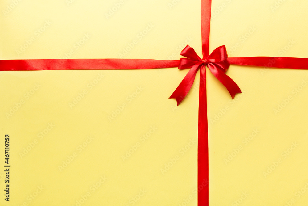 Top view of Red ribbon rolled and red bow isolated on colored background. Flat lay with copy space Top view of Red ribbon rolled and red bow isolated on colored background. Flat lay with copy space