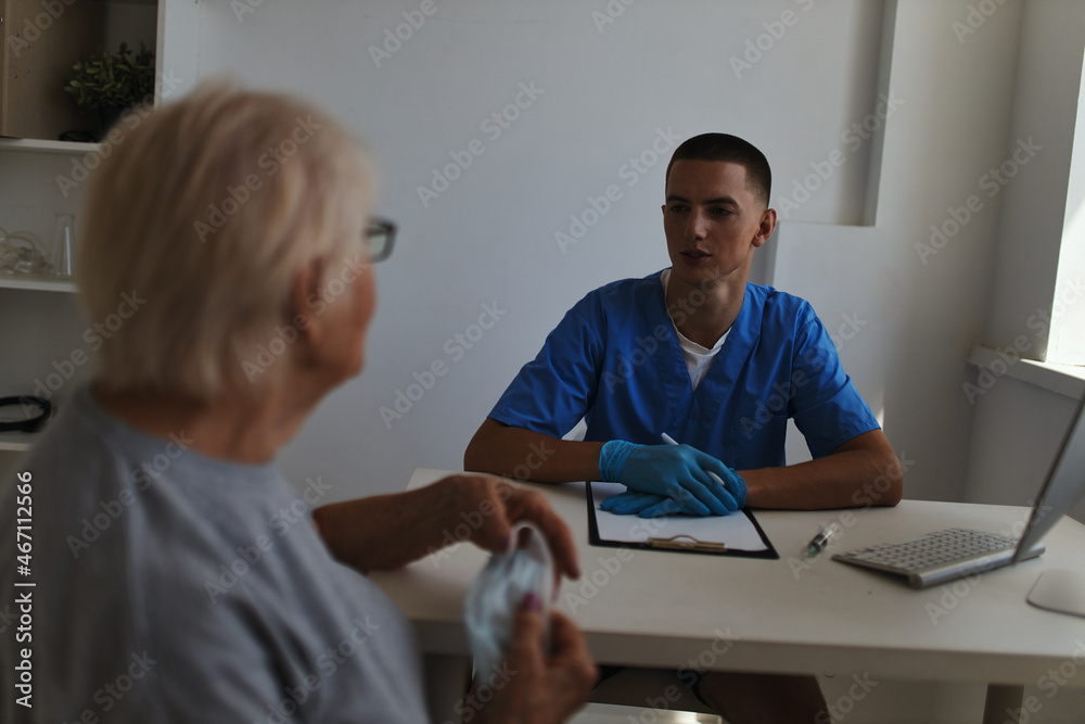 elderly woman patient is examined by a doctor a visit to the hospital elderly woman patient is examined by a doctor a visit to the hospital