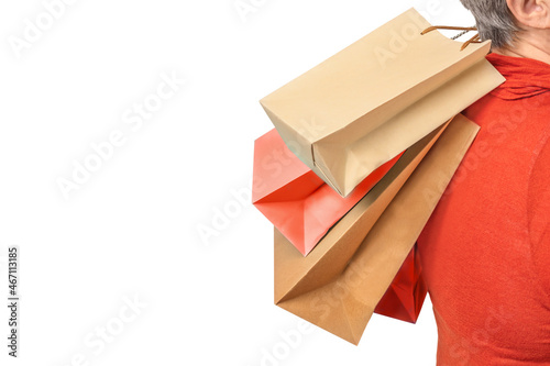 Senior woman holding shopping bags in hands isolated
