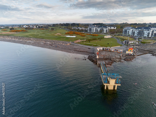 Blackrock public diving board at sunrise. Salthill, Galway city, Ireland. Popular town landmark. Aerial drone view. Dramatic light, High tide.