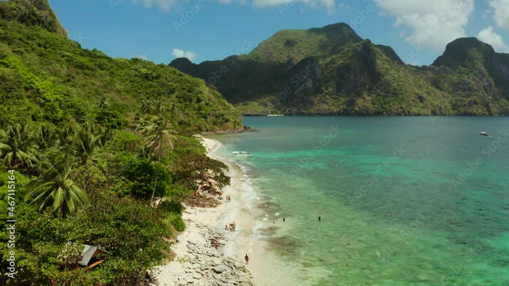 aerial view tropical beach on island with palm trees, blue lagoon and azure clear water. Helicopter Island in El Nido, Palawan Philippines. Tropical landscape with blue lagoon, coral reef aerial view tropical beach on island with palm trees, blue lagoon and azure clear water. Helicopter Island in El Nido, Palawan Philippines. Tropical landscape with blue lagoon, coral reef