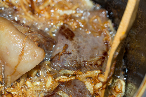 dish of beef in a pan, meat and onions. Appetizing dish. Slow food concept.