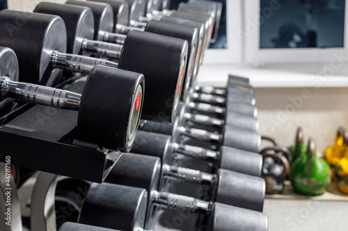 shelves with rows of gray dumbbells