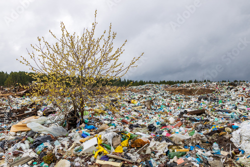 Verkhnie-Sergi, Russia - May 02, 2021. gray cloudy sky over a landfill with a lot of rubbish. problems of contamination of territories with garbage